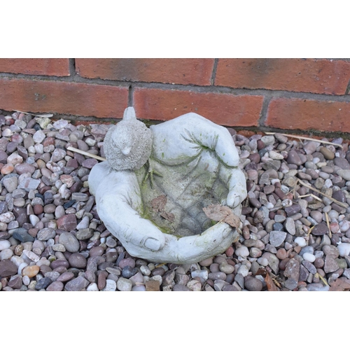 260 - Reconstituted stone model of a bird in hand birdbath. 

Made in England, these items are frost and w... 