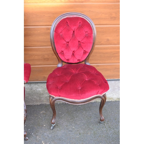 296 - A pair of Edwardian upholstered His and Hers chairs on casters. Signs of old worm. There have been s... 