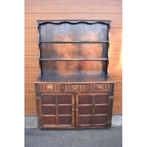 297 - 1930s oak dresser and rack. No back to it. Doors don't stay shut. 124 x 47 x 178cm.