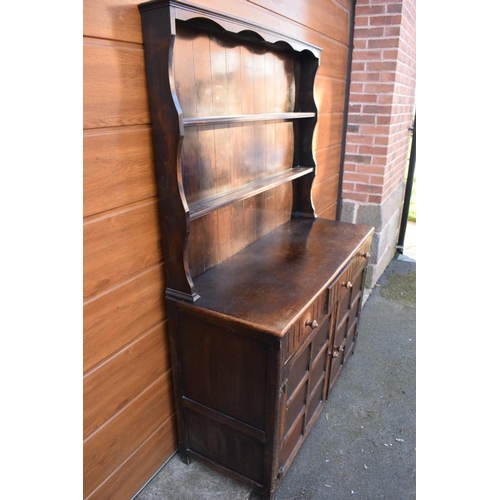 297 - 1930s oak dresser and rack. No back to it. Doors don't stay shut. 124 x 47 x 178cm.