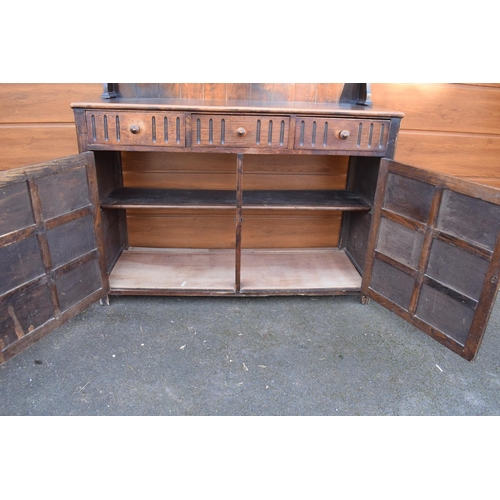 297 - 1930s oak dresser and rack. No back to it. Doors don't stay shut. 124 x 47 x 178cm.