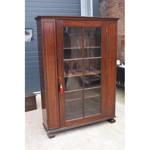 306 - Large Victorian mahogany bookcase on carved feet with foldout sides and a glass panelled door. 3 adj... 