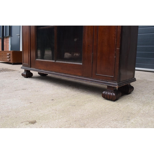 306 - Large Victorian mahogany bookcase on carved feet with foldout sides and a glass panelled door. 3 adj... 