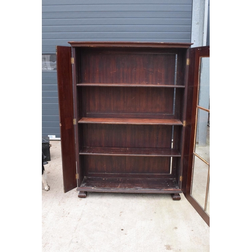 306 - Large Victorian mahogany bookcase on carved feet with foldout sides and a glass panelled door. 3 adj... 