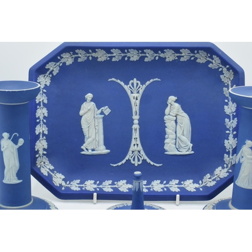 52 - A good collection of Wedgwood Jasperware in the dip blue colour to include 2 pairs of candlesticks, ... 