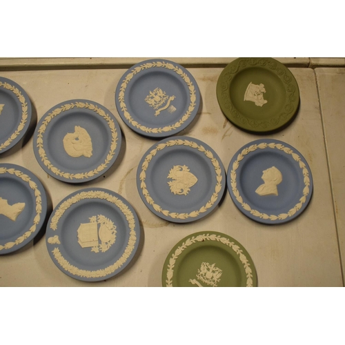 53 - A collection of Wedgwood Jasperware to include vases, trinkets, cruets etc in a range of colours to ... 