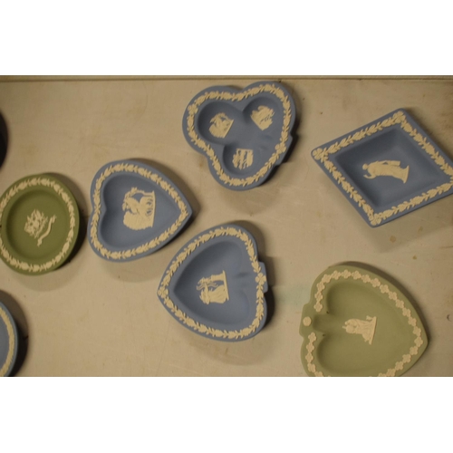 53 - A collection of Wedgwood Jasperware to include vases, trinkets, cruets etc in a range of colours to ... 