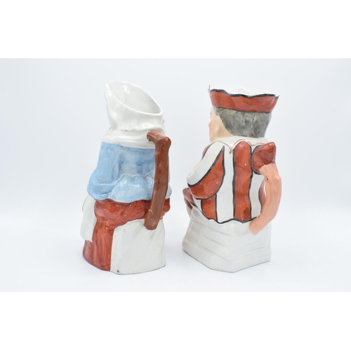 66 - A pair of 19th century large Staffordshire Toby jugs to consist of Punch and Judy (2). Some paint lo... 