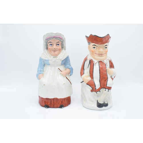 66 - A pair of 19th century large Staffordshire Toby jugs to consist of Punch and Judy (2). Some paint lo... 