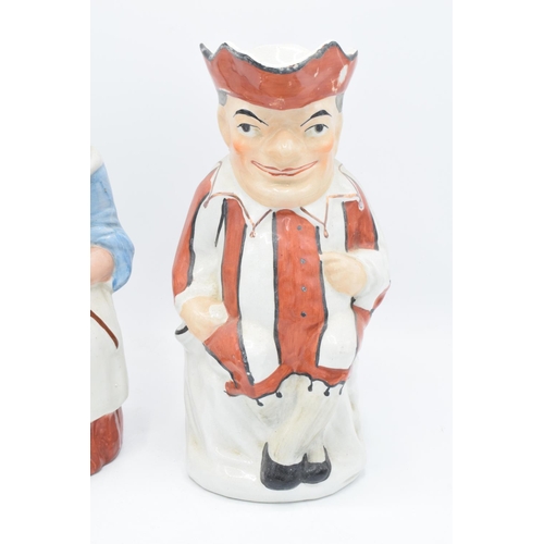 66 - A pair of 19th century large Staffordshire Toby jugs to consist of Punch and Judy (2). Some paint lo... 