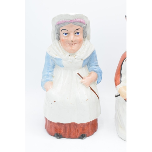 66 - A pair of 19th century large Staffordshire Toby jugs to consist of Punch and Judy (2). Some paint lo... 