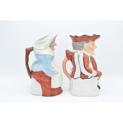 66 - A pair of 19th century large Staffordshire Toby jugs to consist of Punch and Judy (2). Some paint lo... 