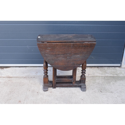 304 - 18th century thick oak drop-leaf gate leg table. 74cm tall.