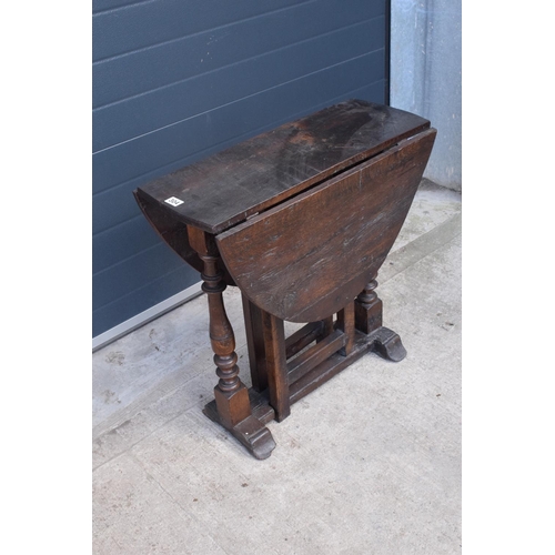 304 - 18th century thick oak drop-leaf gate leg table. 74cm tall.