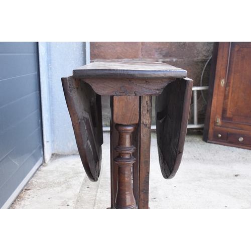 304 - 18th century thick oak drop-leaf gate leg table. 74cm tall.