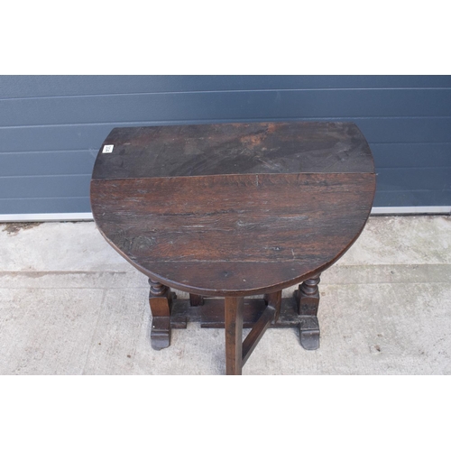 304 - 18th century thick oak drop-leaf gate leg table. 74cm tall.