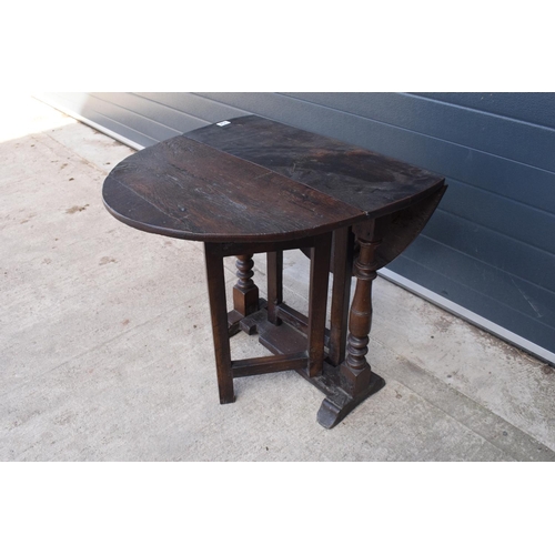 304 - 18th century thick oak drop-leaf gate leg table. 74cm tall.