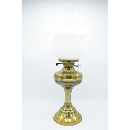 100 - A large Edwardian brass oil lamp complete with an associated funnel and shade. In good condition. Ch... 