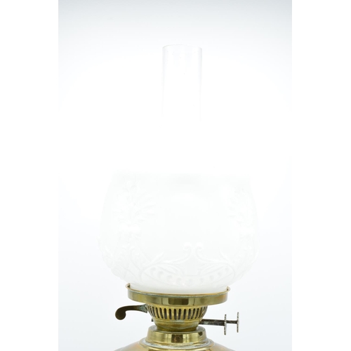 100 - A large Edwardian brass oil lamp complete with an associated funnel and shade. In good condition. Ch... 