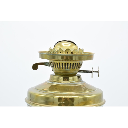 100 - A large Edwardian brass oil lamp complete with an associated funnel and shade. In good condition. Ch... 