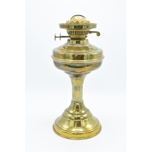 100 - A large Edwardian brass oil lamp complete with an associated funnel and shade. In good condition. Ch... 