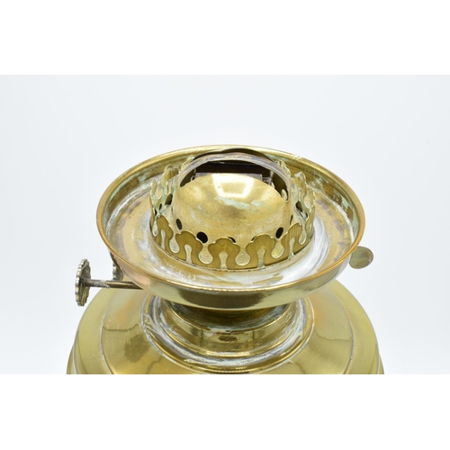 100 - A large Edwardian brass oil lamp complete with an associated funnel and shade. In good condition. Ch... 