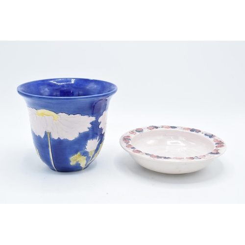 106 - Lise B Moorcroft pottery to include a blue daisy vase and a shallow bowl decorated with grapes (2). ... 