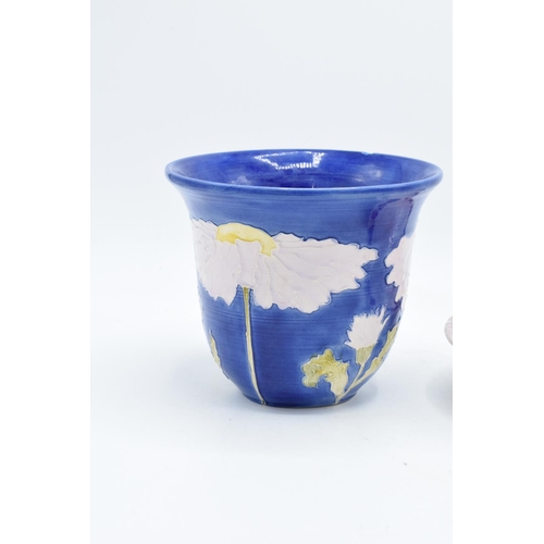 106 - Lise B Moorcroft pottery to include a blue daisy vase and a shallow bowl decorated with grapes (2). ... 