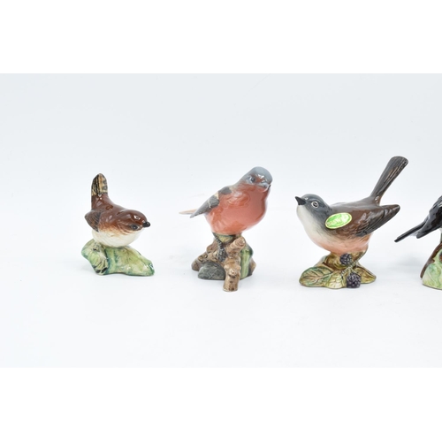 160 - A collection of Beswick birds to include a Wren, Chaffinch, Whitethroat, stone chat, blue tit ands a... 