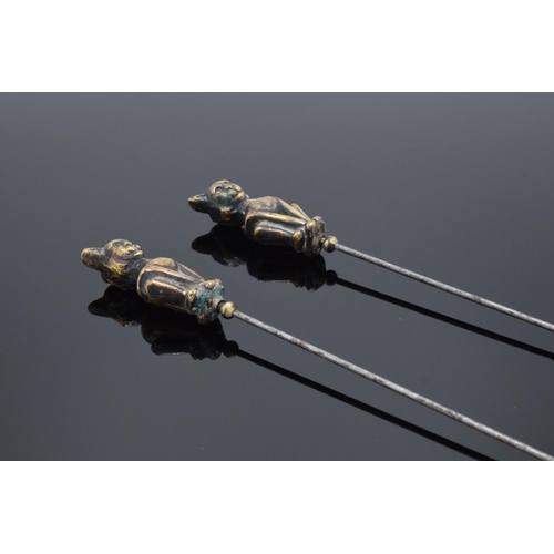 204 - Pair of Victorian brass and steel cat hatpins, 22cm long