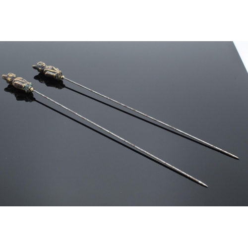 204 - Pair of Victorian brass and steel cat hatpins, 22cm long