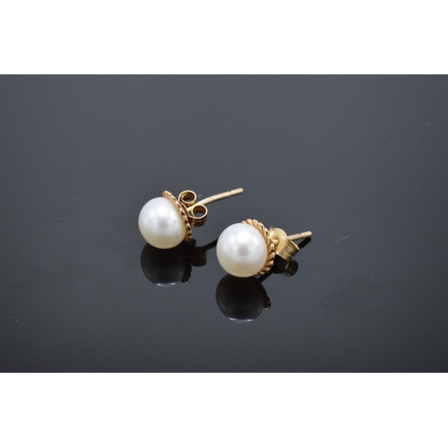 220 - A pair of 9ct gold earrings with pearls. Gross weight 1.2 grams. Unmarked but test as 9ct.