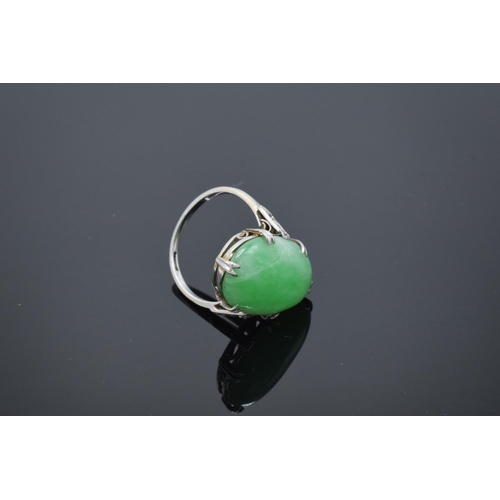 228 - Ladies platinum set jade & diamond ring: Jade or similar hardstone cabochon gemstone with diamond ch... 