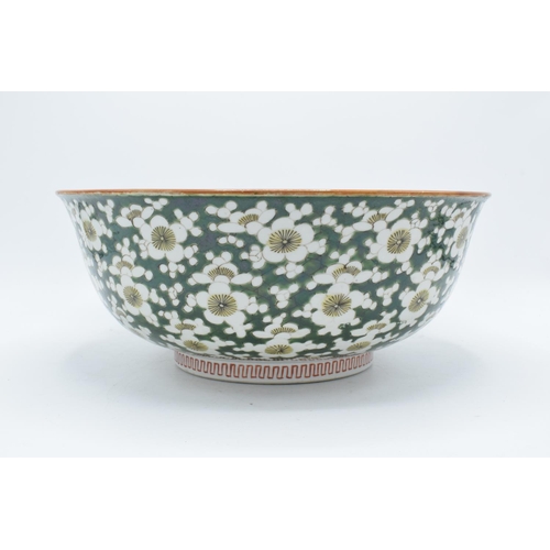 24 - A large late 19th/ early 20th century Japanese thick porcelain bowl with a floral green design. Show... 