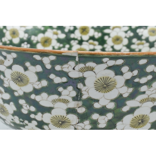24 - A large late 19th/ early 20th century Japanese thick porcelain bowl with a floral green design. Show... 