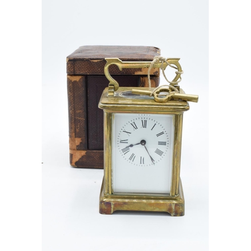 241 - 19th century brass carriage clock with an enamel face and a single train movement in a leather trave... 