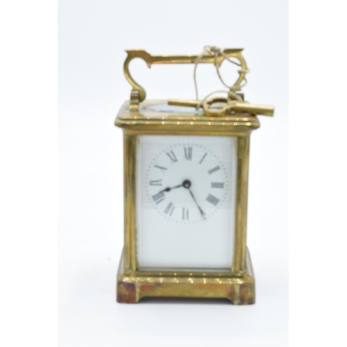 241 - 19th century brass carriage clock with an enamel face and a single train movement in a leather trave... 