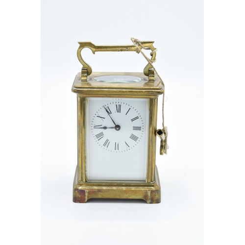 241 - 19th century brass carriage clock with an enamel face and a single train movement in a leather trave... 