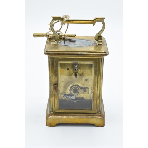 241 - 19th century brass carriage clock with an enamel face and a single train movement in a leather trave... 