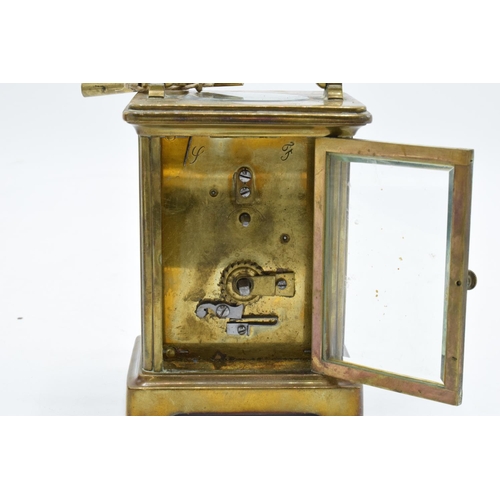 241 - 19th century brass carriage clock with an enamel face and a single train movement in a leather trave... 