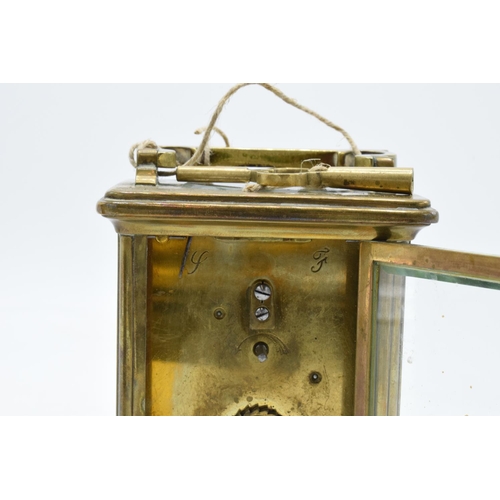 241 - 19th century brass carriage clock with an enamel face and a single train movement in a leather trave... 