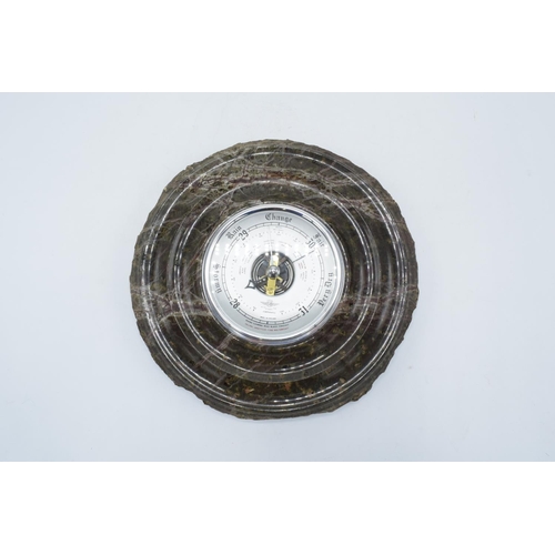 253 - Circular wall barometer made from Cornish serpentine stone (untested). In good condition. 24cm diame... 