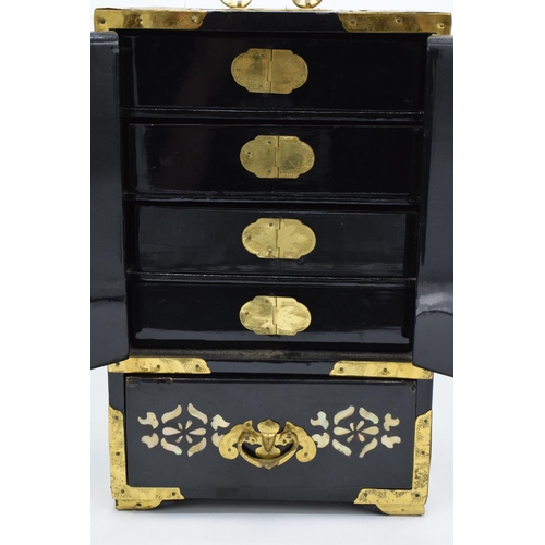 273 - A 20th century Chinese lacquer-style jewellery box with fold and doors and pull out drawers. In good... 