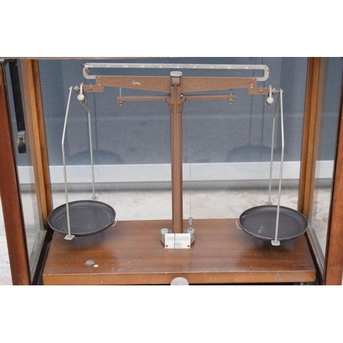 276 - A early-mid 20 century wooden cased set of laboratory scales made WBN of Glasgow. Sold as decorative... 