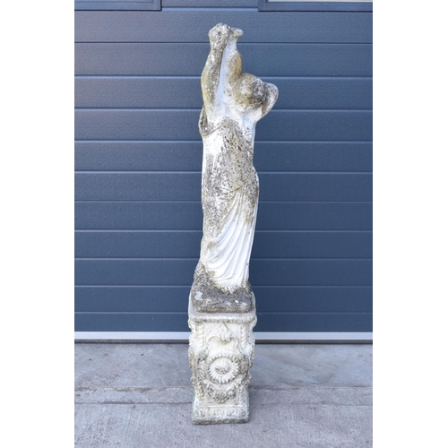 282 - A late 20th century large garden statue of a lady in robes holding a pale on an ornate square base m... 