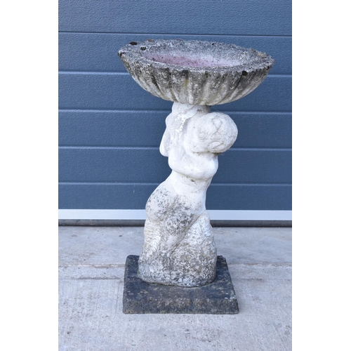 283 - A vintage garden statue in the form of a cherub bird bath on a base, 64cm tall made from reconstitut... 