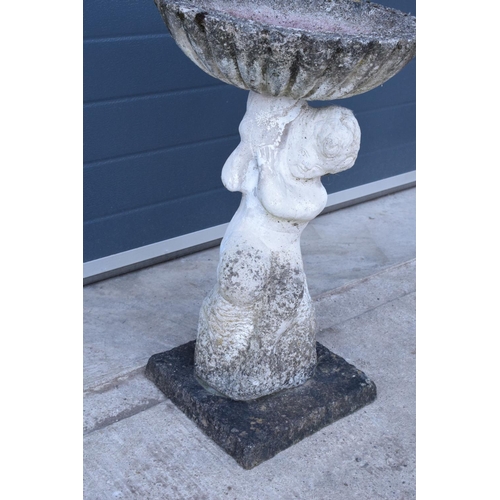 283 - A vintage garden statue in the form of a cherub bird bath on a base, 64cm tall made from reconstitut... 