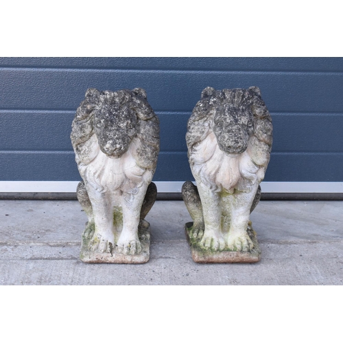 284 - A pair of late 20th proud lions  made from reconstituted stone/concrete. 43cm tall.