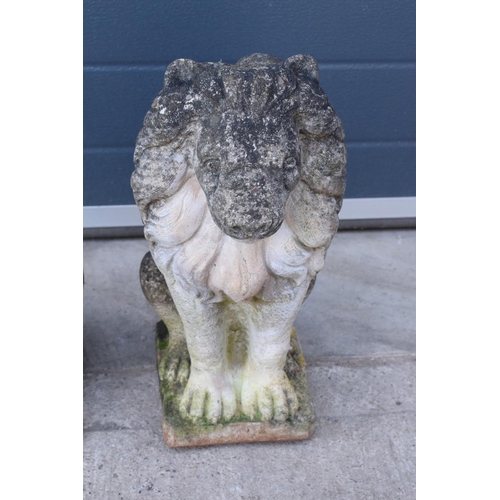 284 - A pair of late 20th proud lions  made from reconstituted stone/concrete. 43cm tall.