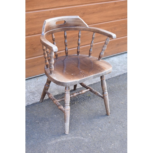 290 - A reproduction wooden captains chair. 76cm tall. In good sturdy condition with some marks, water sta... 